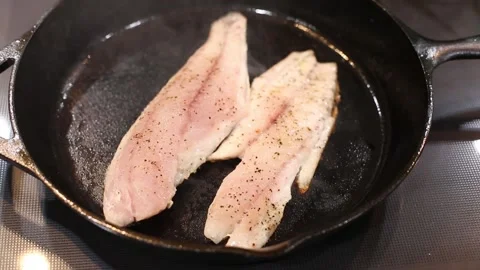 Fry Coooking Red Fish White Meat on Cast Iron skillet video Stock Footage 137744504