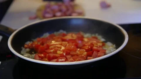 Fry delicious scrambled eggs with tomatoes, onions, and sausages. Time laps Stock Footage 81630852