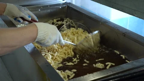 Fry the dough in a deep fryer close-up Stock Footage 221818045