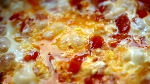 Fry eggs and vegetables in a frying pan close-up.  Stock Footage 269907314