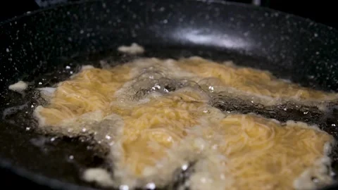 Fry fish in batter Extreme close up and slow motion of hot oil foaming or Stock Footage 319931319