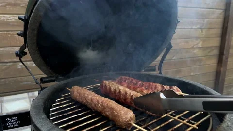 Fry kebab on the grill, the meat on the grate goes smoke Stock Footage 197074018