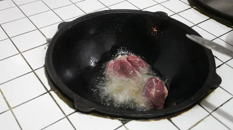 Fry the meat in a big pot Stock Footage 44230980