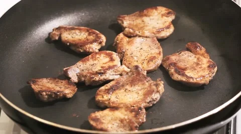 Fry the meat in a frying pan, Chef preparing and spicing meat restaurant kitchen Stock Footage 65449186