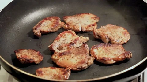 Fry the meat in a frying pan, Chef preparing and spicing meat restaurant kitchen Stock Footage 65449218