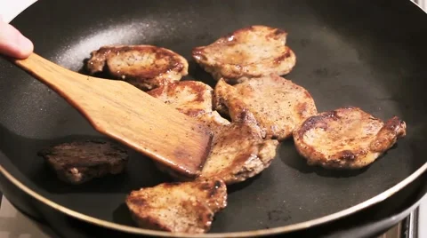 Fry the meat in a frying pan, Chef preparing and spicing meat restaurant kitchen Stock Footage 65449231