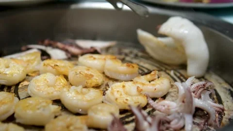 Fry octopus and shrimp Seafood is fried in a pan. A variety of mussels, shrimps Stock Footage 303856560