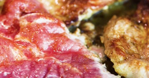Fry pieces of pork steak in vegetable oil in a pan over high heat. flat lay Stock Footage 217359341