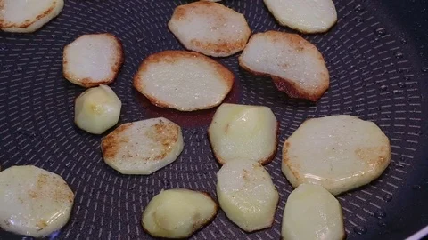 Fry potatoes in a frying pan Stock Footage 74898625