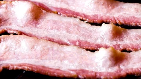 Fry the raw bacon slices in a pan. Concept of fresh and Tasteful Ingredient. 스톡 동영상 334643211