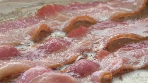 Fry the raw bacon slices in a pan. Concept of fresh and Tasteful Ingredient. 스톡 동영상 334643215
