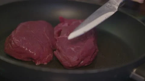 Fry raw steaks in pan Stock Footage 152850254