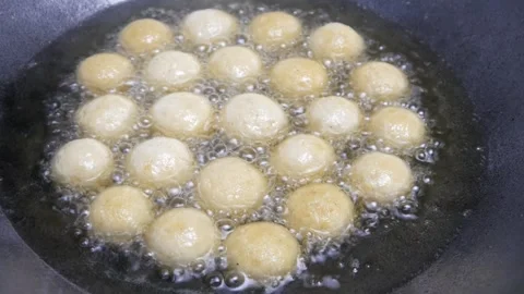 Fry the round tofu in a pan with hot oil Stock Footage 321980123