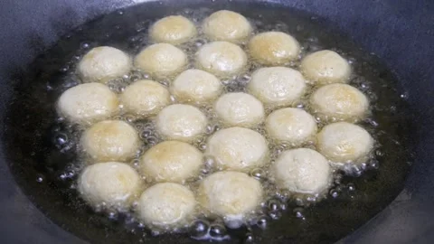 Fry the round tofu in a pan with hot oil Stock Footage 321980132
