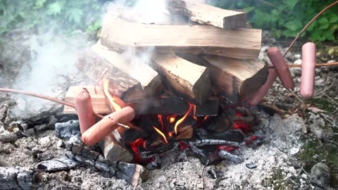 Fry sausages on a fire 4K Stock Footage 93595879