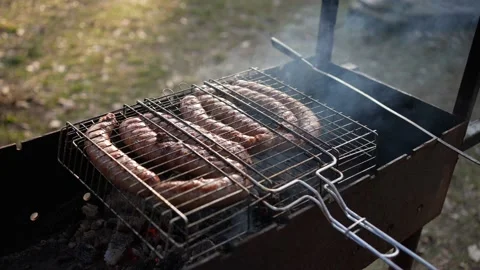 Fry sausages on the grill Stock Footage 240014457