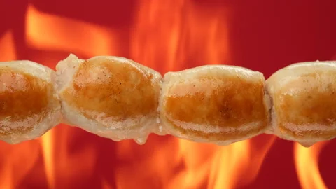 Fry sausages on open fire Stock-Footage 194780995