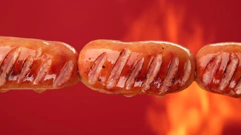 Fry sausages on open fire , sliding shot Видео 195438459