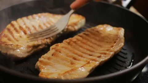 Fry steak meat. closeup. pork in a frying pan Stock Footage 72300257