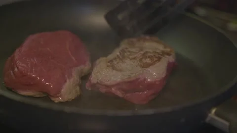 Fry steaks in pan Stock Footage 152849846