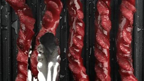 Fry thin sausages on grill top view Video stock 137932309