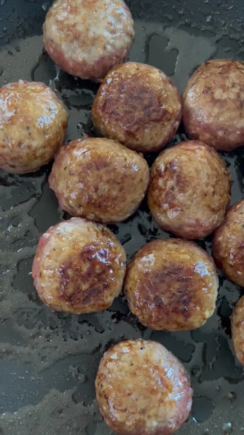 Fryed meatballs on black background, top view, Stock Footage 256052330
