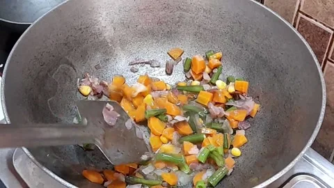 Frying and saute of vegetables in a pan Stock Footage 138028106