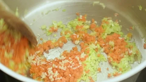 Frying and stirring of chopped vegetables in a pot. Stock Footage 151692444
