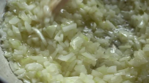 Frying and stirring sliced white onions in a wok pan Stock Footage 134982392