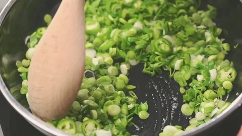 Frying and stirring of vegetables in a frying pan. Stock Footage 150828672
