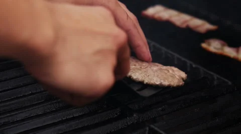 Frying and Turned by Spatula Raw Meat for Burgers on the Grill Stock Footage 62655553