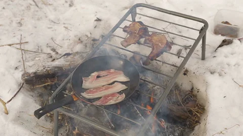 Frying bacon and steaks on a bonfire in the winter in the snow. close-up Stock Footage 85903483
