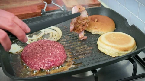 Frying bacon with burger ingredients. Stock Footage 153755046