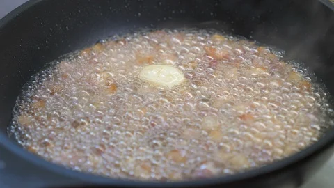 Frying the bacon with the butter in the pan - close up Stock-Footage 90430182