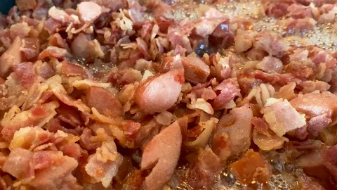 Frying bacon cubes on pan Stock Footage 119597622