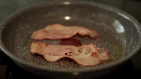 Frying bacon erupts in slow motion Stock Footage 108768228