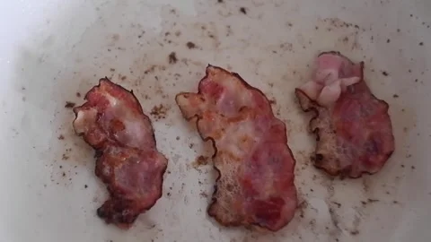 Frying bacon in a frying pan Stock Footage 240856663