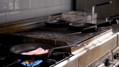Frying bacon on a pan Stock Footage 95970846
