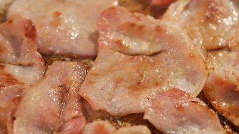 Frying bacon in a pan Stock Footage 101073110