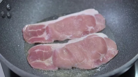 Frying bacon in a pan Stock Footage 142135322
