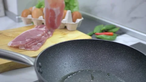 Frying bacon in a pan Stock Footage 142135333