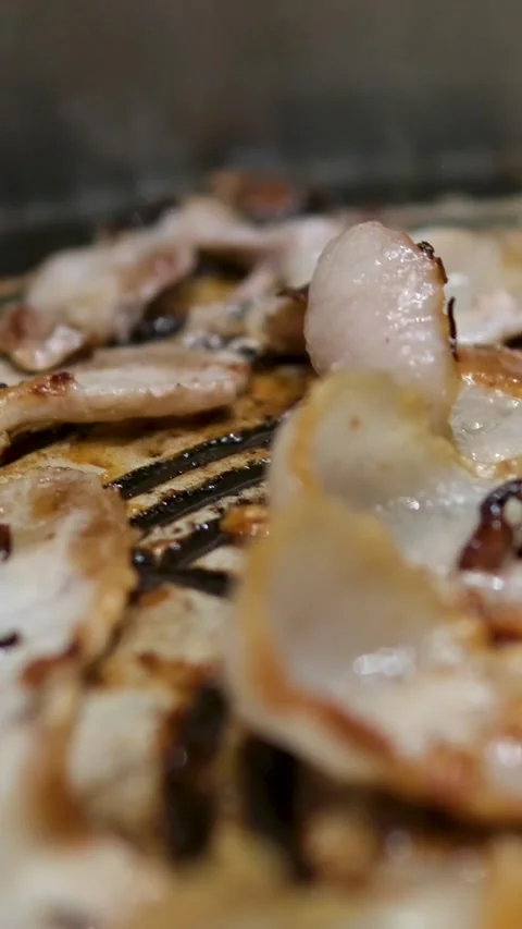 Frying bacon slices in pan, close up. Crispy pieces of delicious Bacon Fried in Stock Footage 309532688