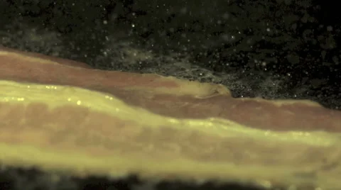 Frying bacon in slow motion Stock Footage 55113838