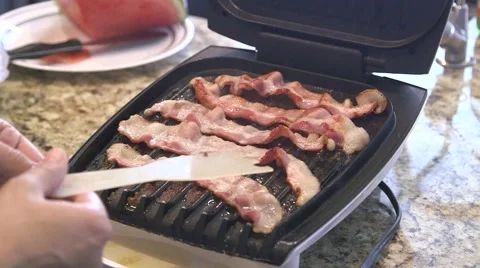 Frying bacon strips Stock Footage 44259479