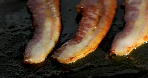 Frying bacon strips. Stock Footage 143976188