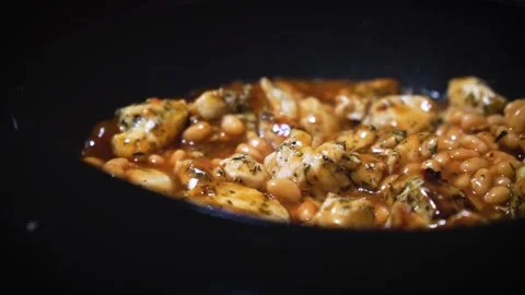 Frying baked beans with chicken on a frying pan simple homemade coo Stock Footage 273124523