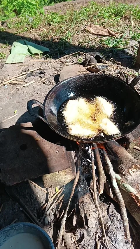 Frying banana fritters Stock Footage 315310516