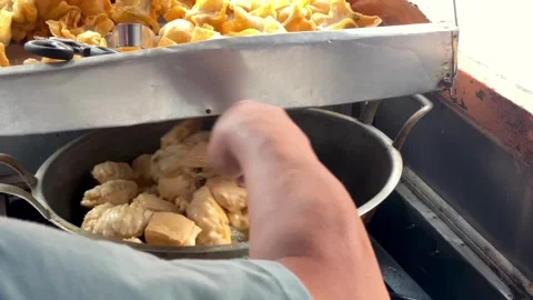 Frying batagor (fried tofu meatball) video in hot oil in a wok Stock Footage 321554902