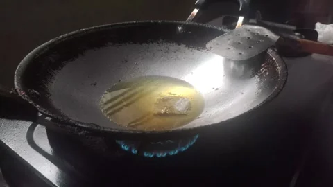 Frying Beef  in Hot Palm Oil Stock Footage 322556440
