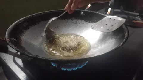 Frying Beef  in Hot Palm Oil Stock Footage 322556443